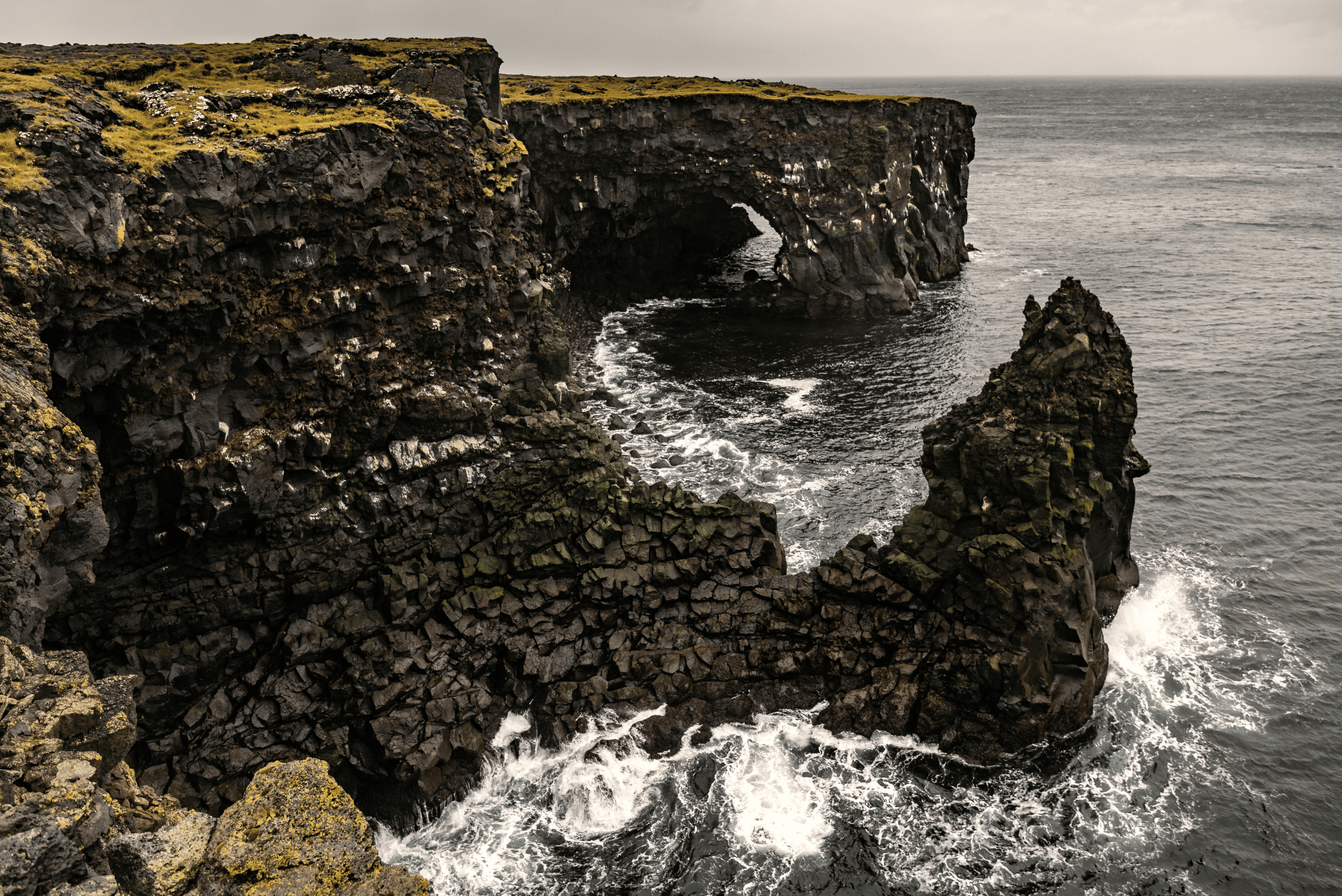 Svörtuloft black lava sea cliffs and arch